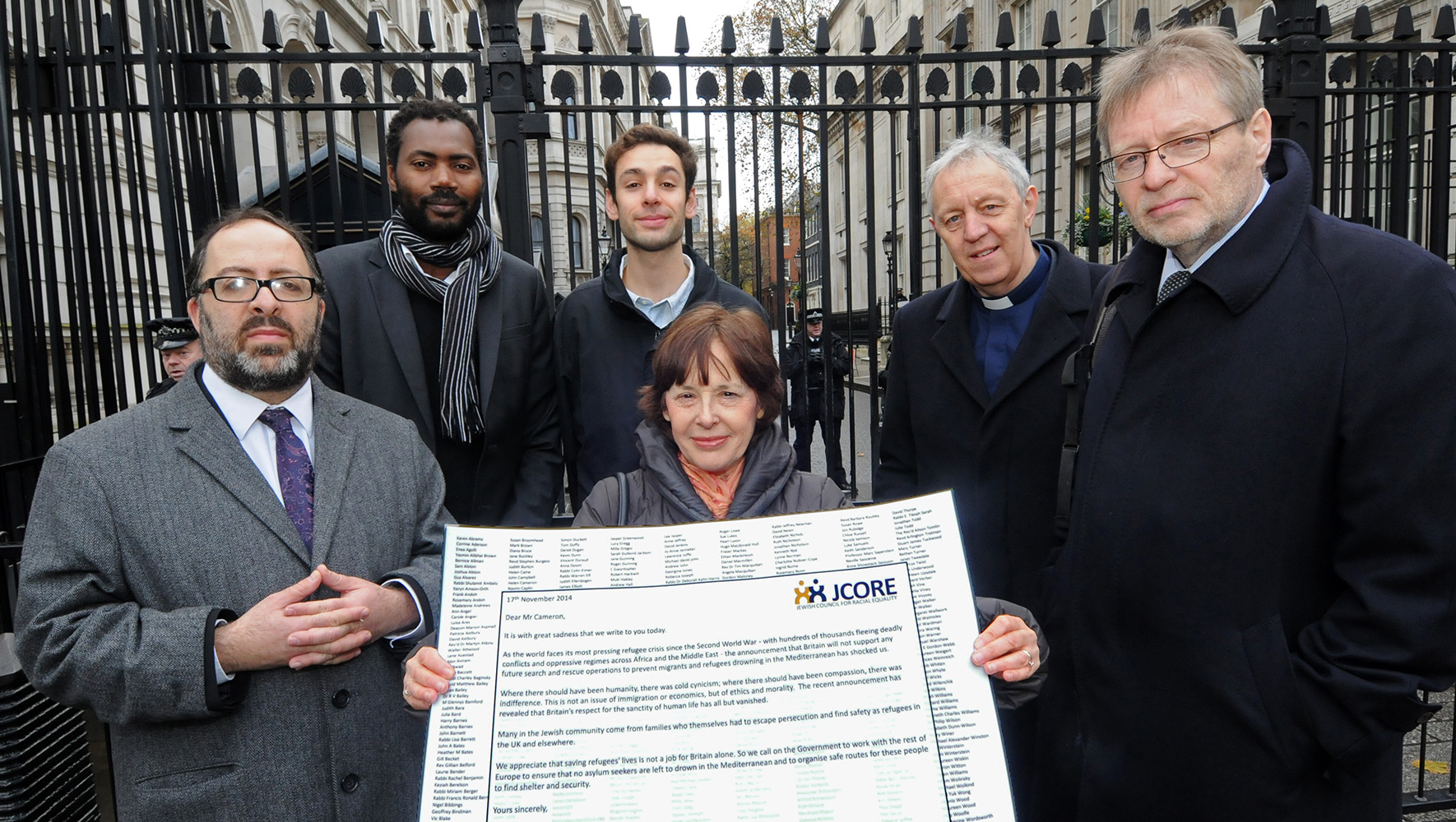 JCORE Honorary President Edie Friedman and a group of faith leaders stand outside Downing Street in 2014. They are holding a petition addressed to David Cameron which calls for the government to open more safe routes for refugees.