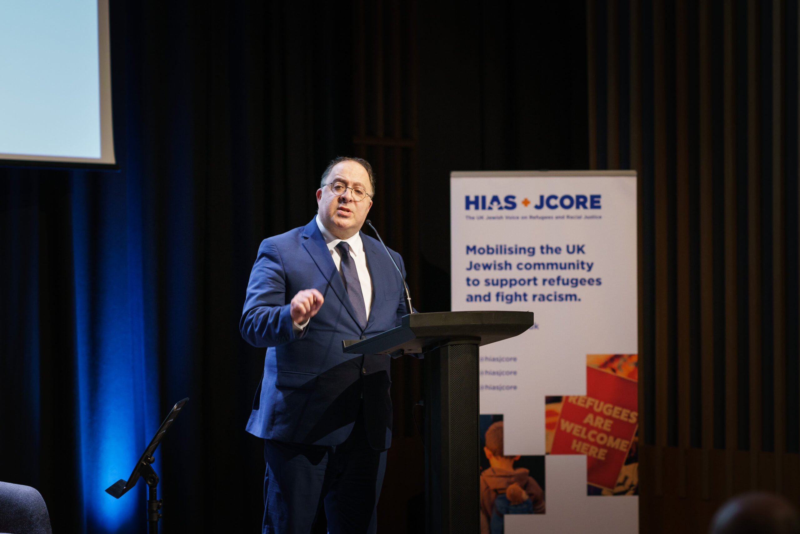 HIAS+JCORE Executive Director David Mason talks at a lectern at the launch event.