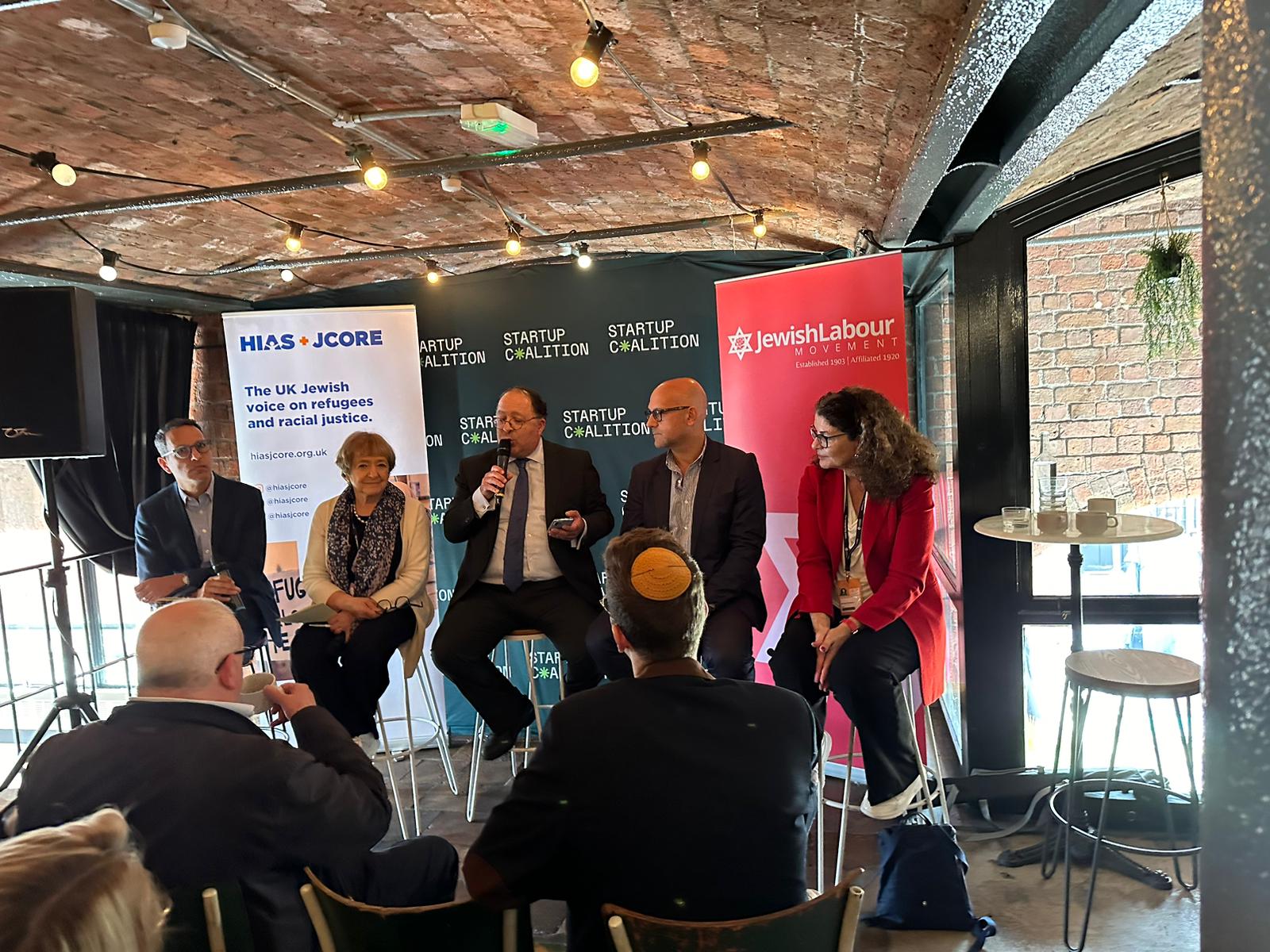 HIAS+JCORE's Executive Director David Mason sits at a panel with Dame Margaret Hodge MP, Dame Diana Johnson MP, Enver Solomon and Maurice Helfgott.